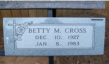 Gray engraved memorial plaque for Betty M. Cross with floral cross design and dates Dec. 10, 1927–Jan. 8, 1983