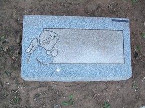 Blue granite grave marker with an engraved cartoon angel on the left side