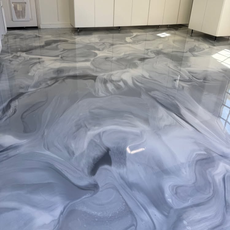 Gray swirled epoxy floor in a modern kitchen with white cabinets and glossy reflections