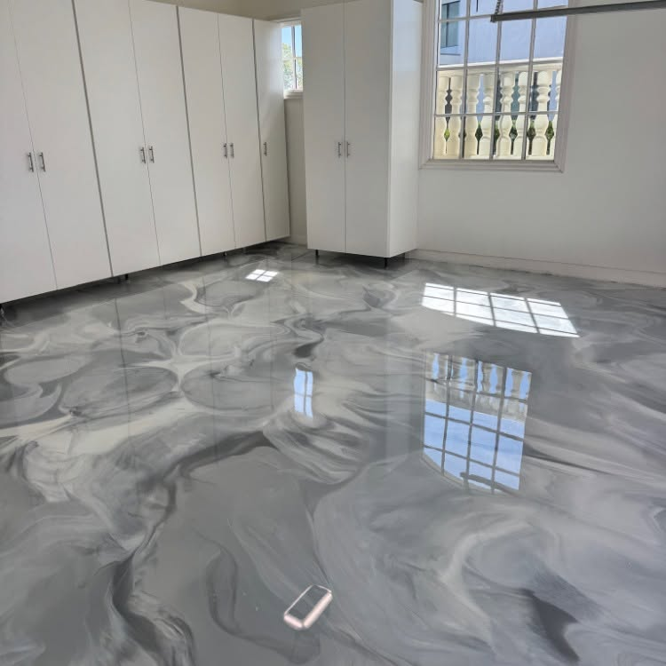 Empty room with glossy gray marble floor, white cabinets, and sunlight from a window