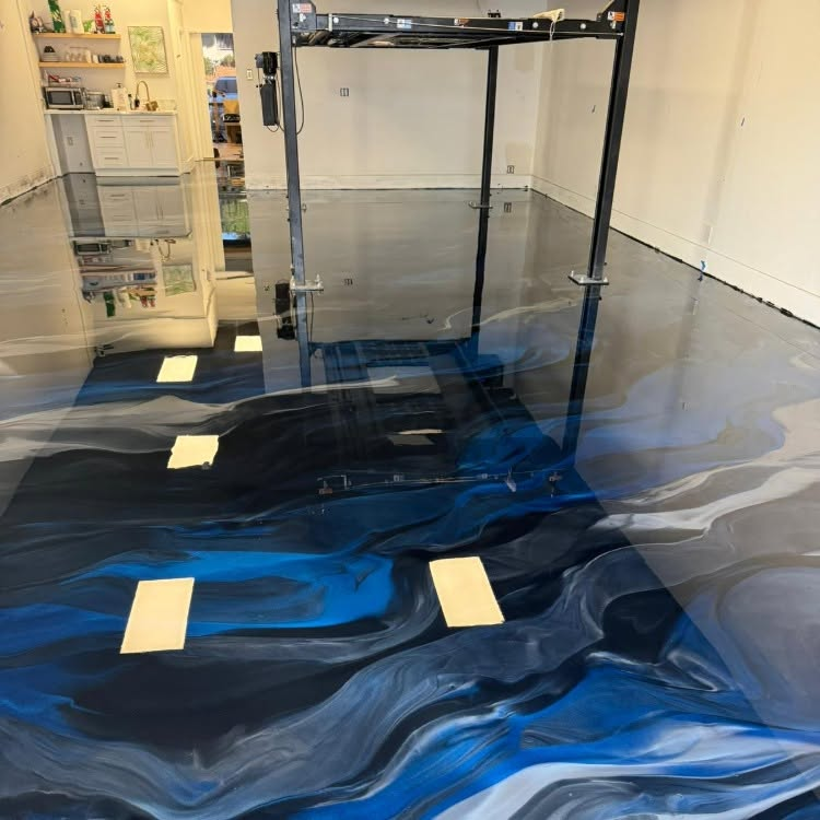 Blue and black marbled resin floor with masking tape in a room under construction