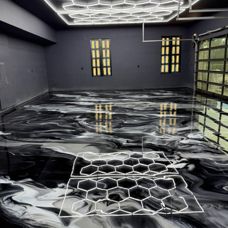 Empty modern room with glossy black marbled floor, dark walls, hexagonal ceiling lights, and glass door windows