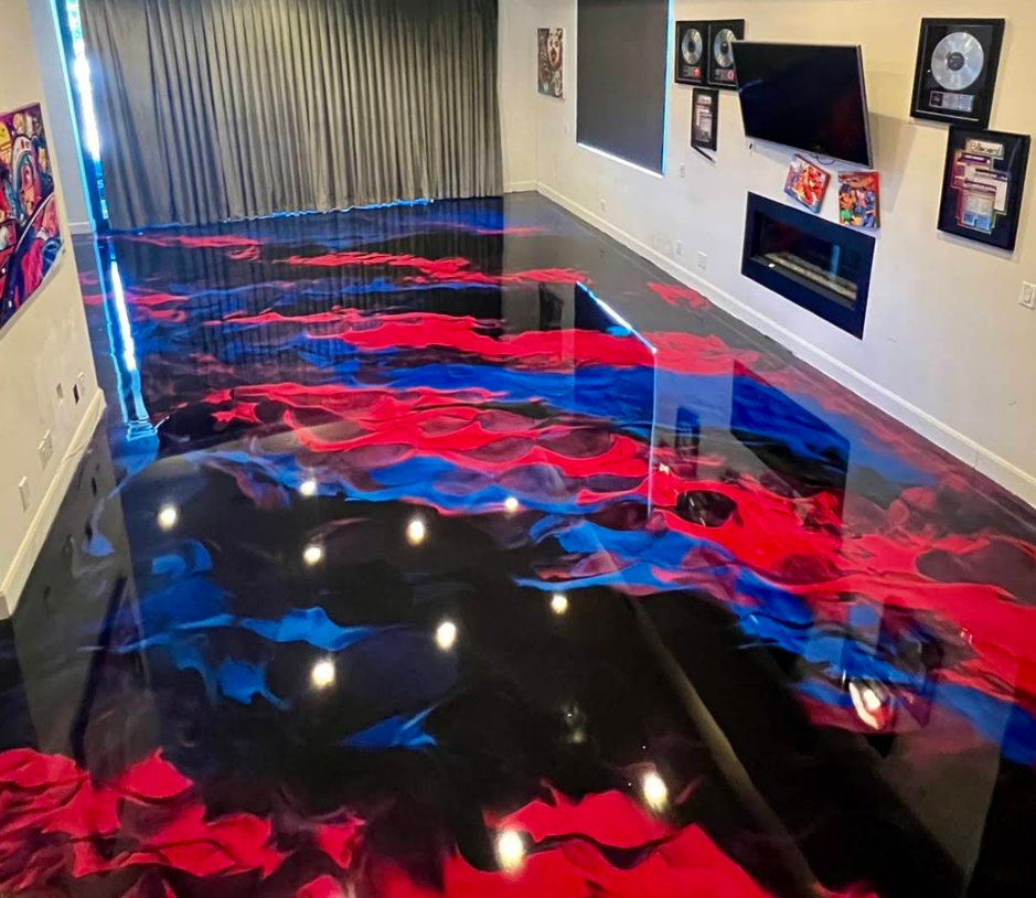 Glossy black floor with red and blue swirls in a room with framed music awards and a curtain