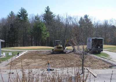 A construction site with a bulldozer and a truck in the background