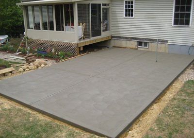 A close up of a concrete floor with a pattern of rocks.