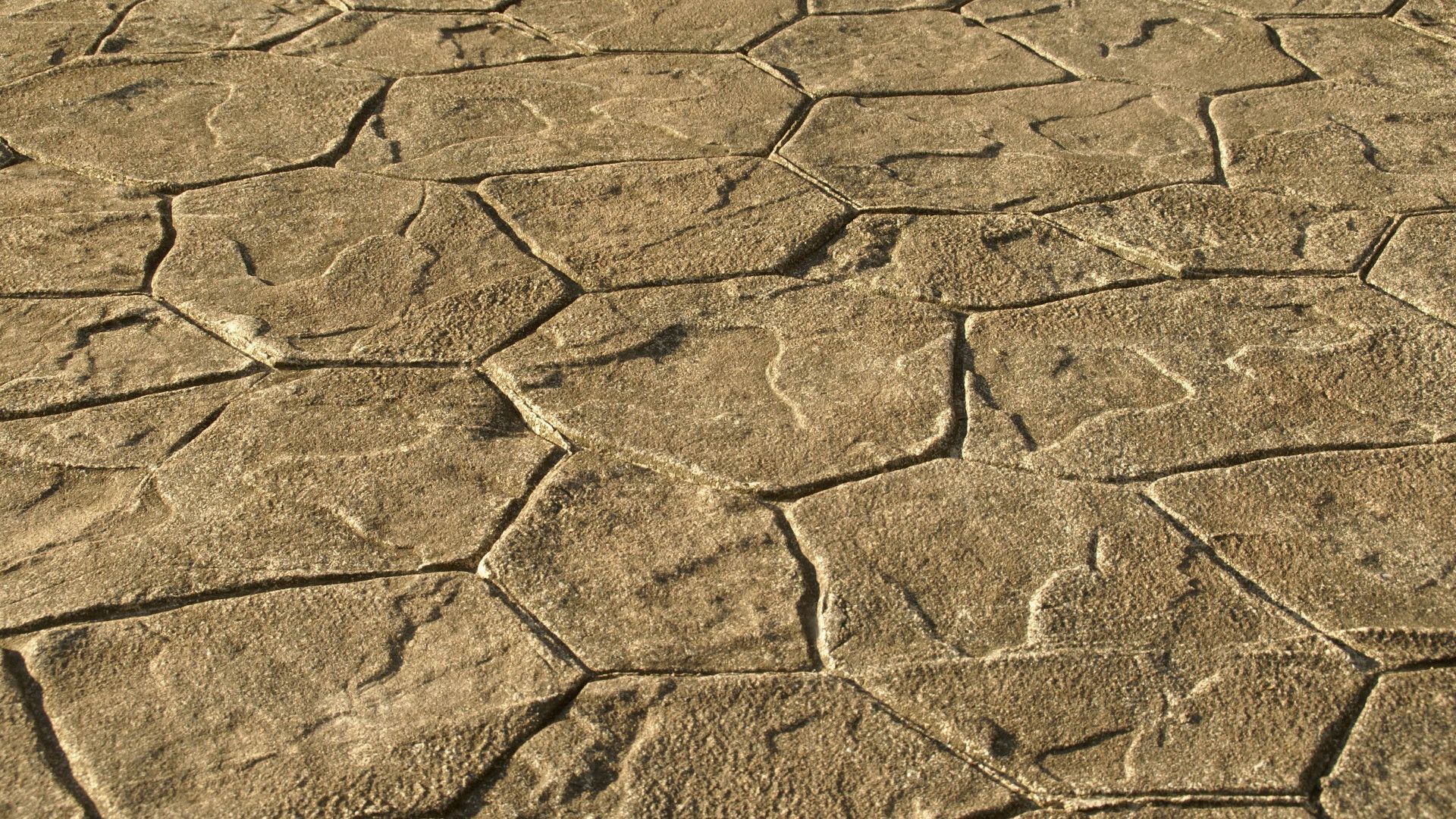 A close up of a brick floor with a geometric pattern.