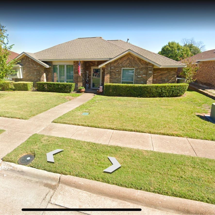 A brick house with stairs leading up to the front door