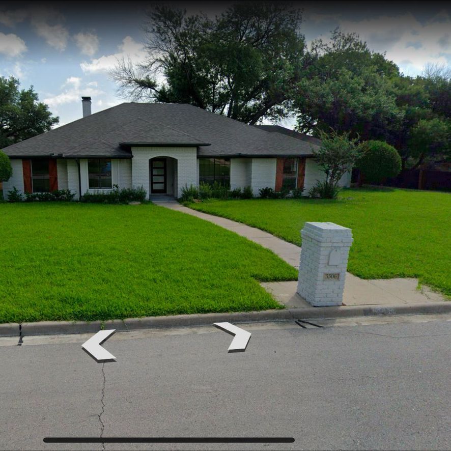 A brick house with a lush green lawn is shown on google maps