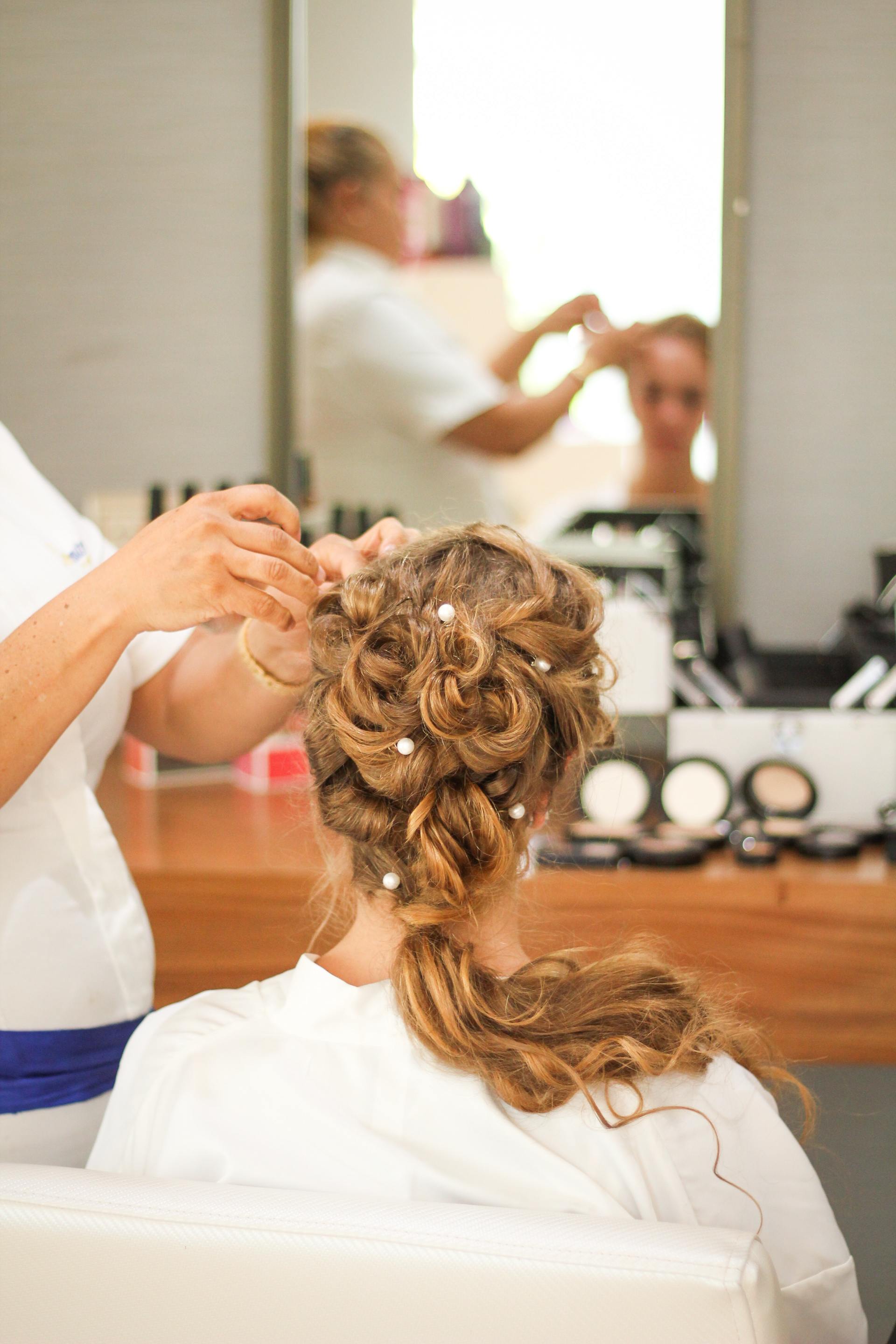 Bride getting hair styled
