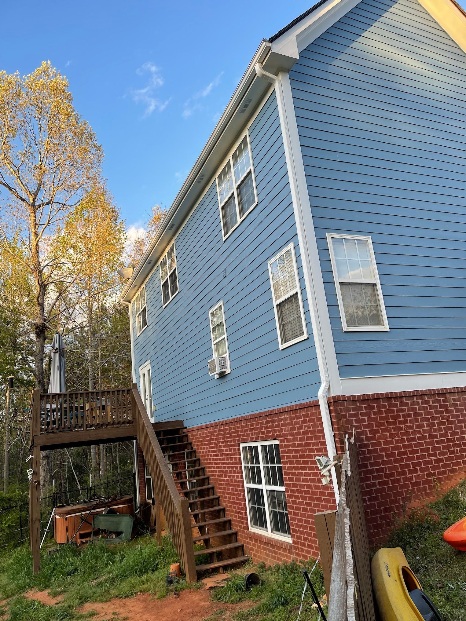 A blue house with stairs leading up to the second floor