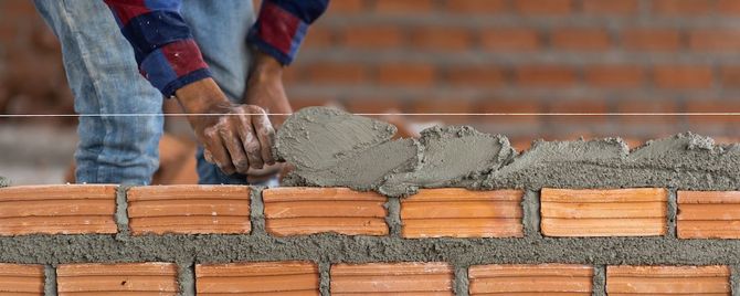 Bricklaying with mortar on a wall in progress