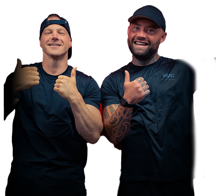 Two men are standing next to each other and giving a thumbs up