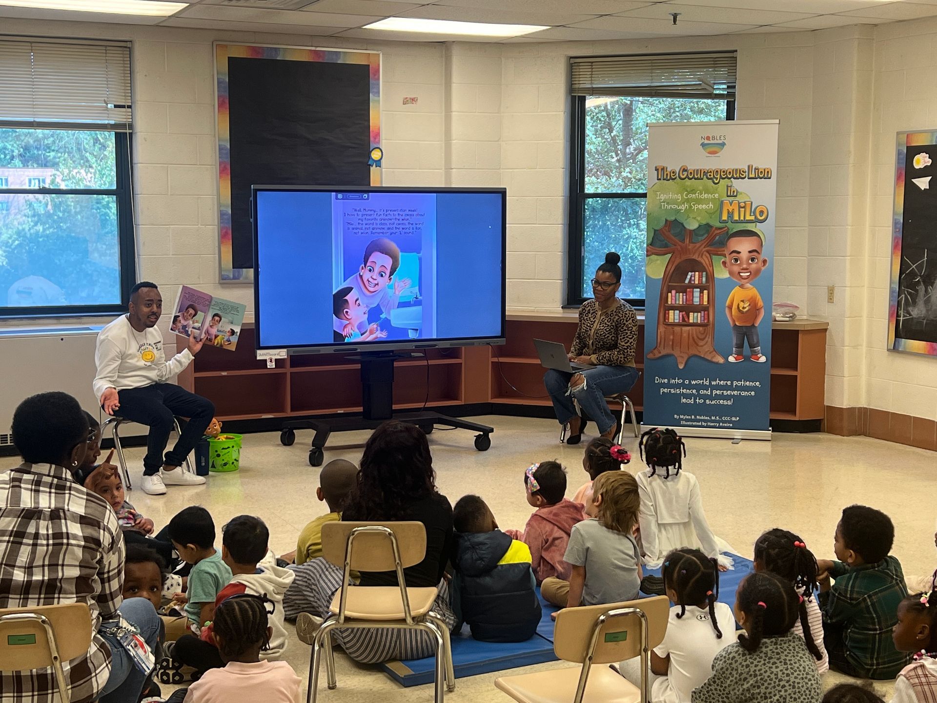 A group of children are sitting in a classroom watching a presentation.