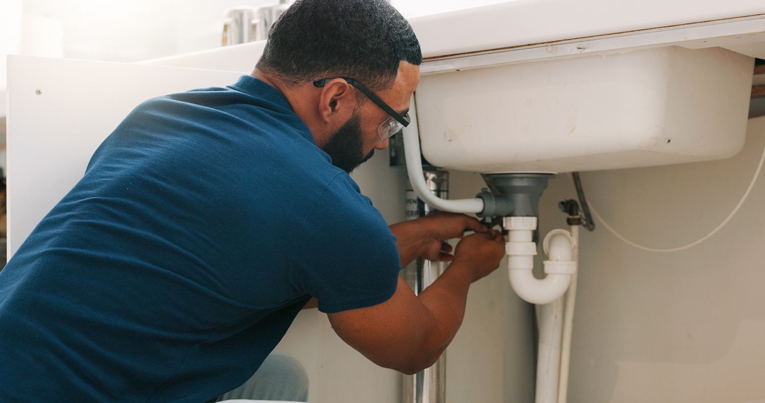 A man is repairing a pipe.