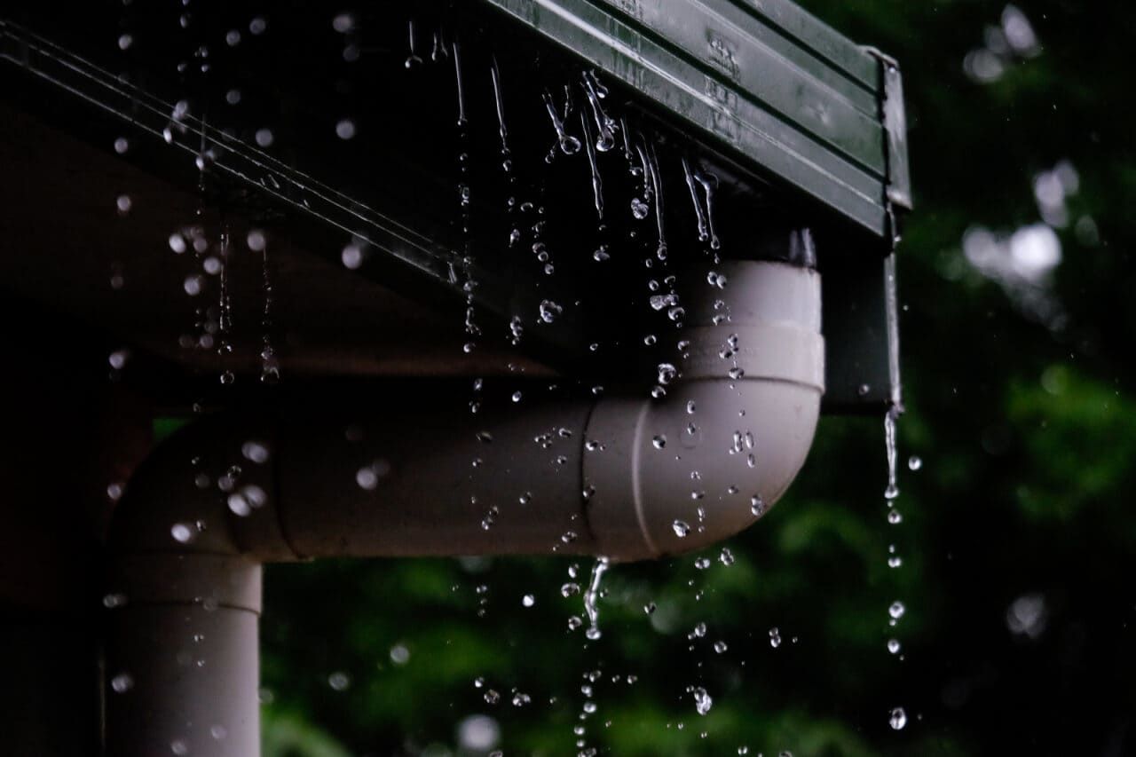 Rain Is Falling from The Gutter of A House — Roof Masters NQ in Douglas, QLD