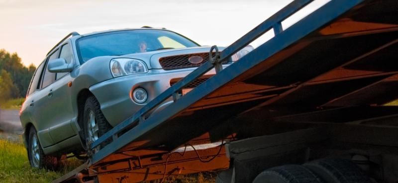 car being loaded onto towing truck