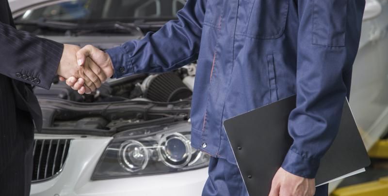 mechanic shaking customers hand