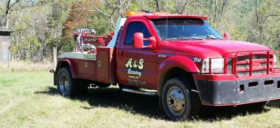 A & S recovery red towing truck