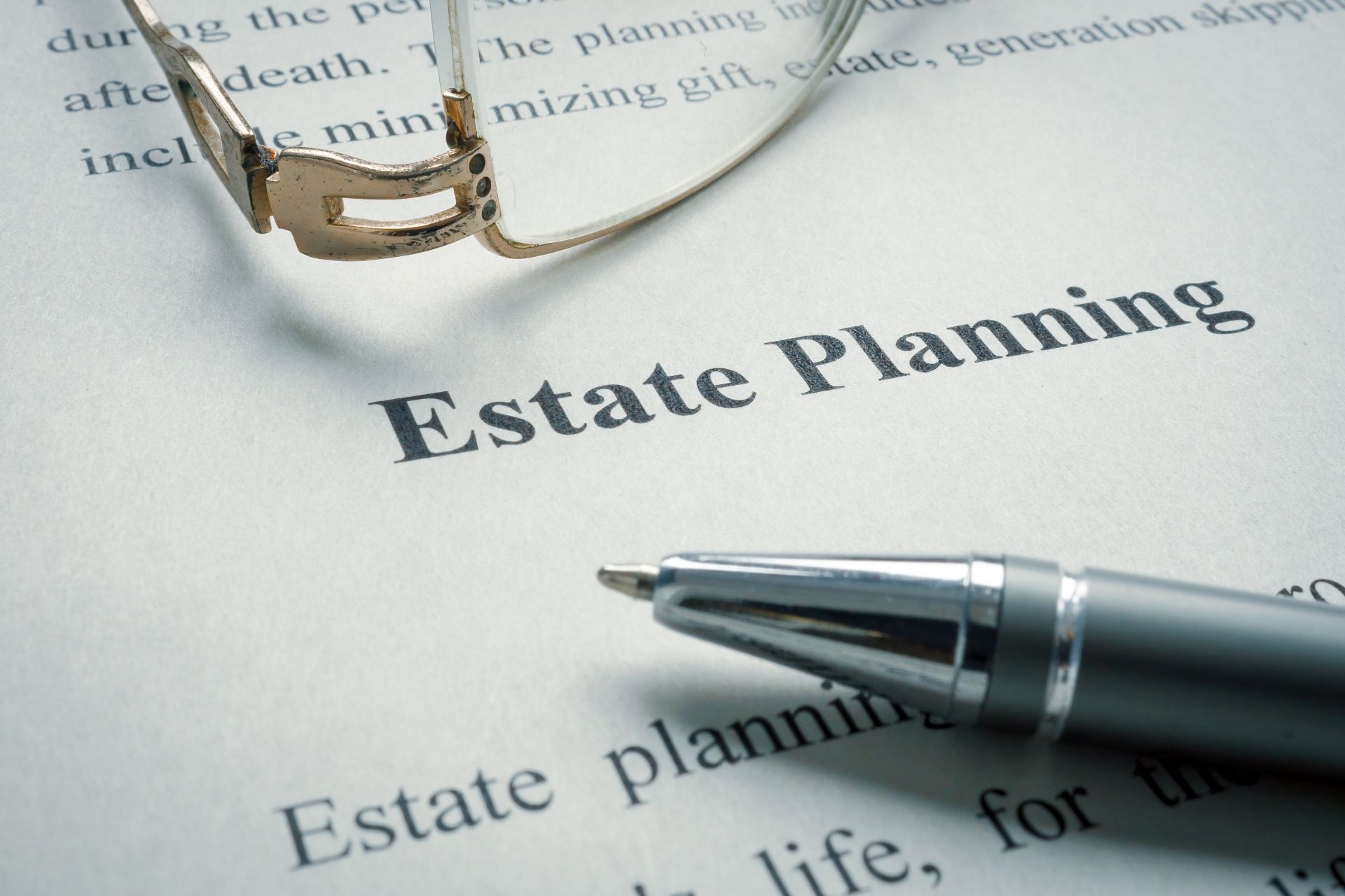 Estate planning document with eyeglasses and a pen on top