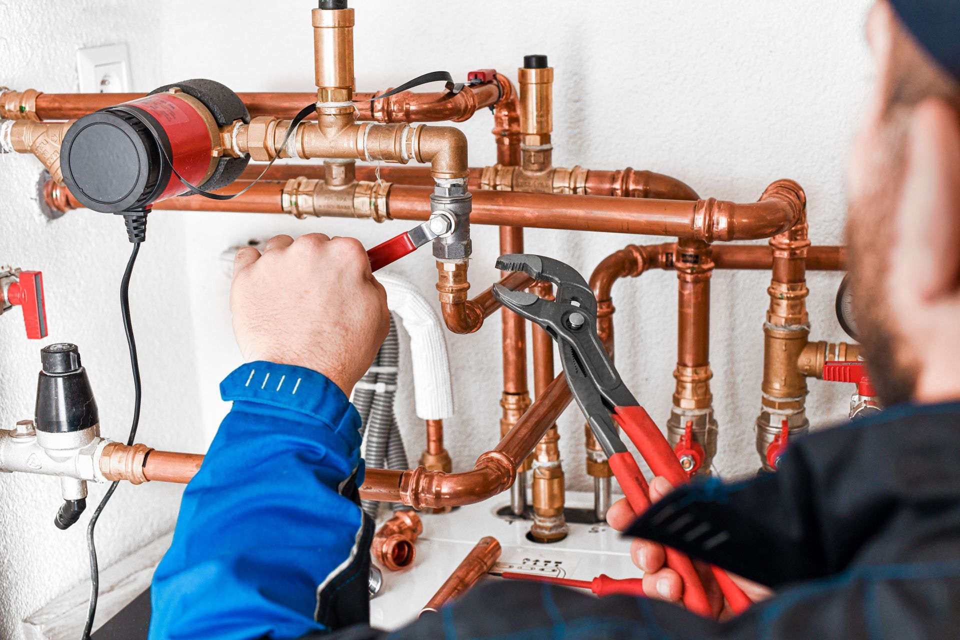 A commercial plumbing contractor installing piping for a plumbing system. A commercial plumbing contractor installing piping for a plumbing system.