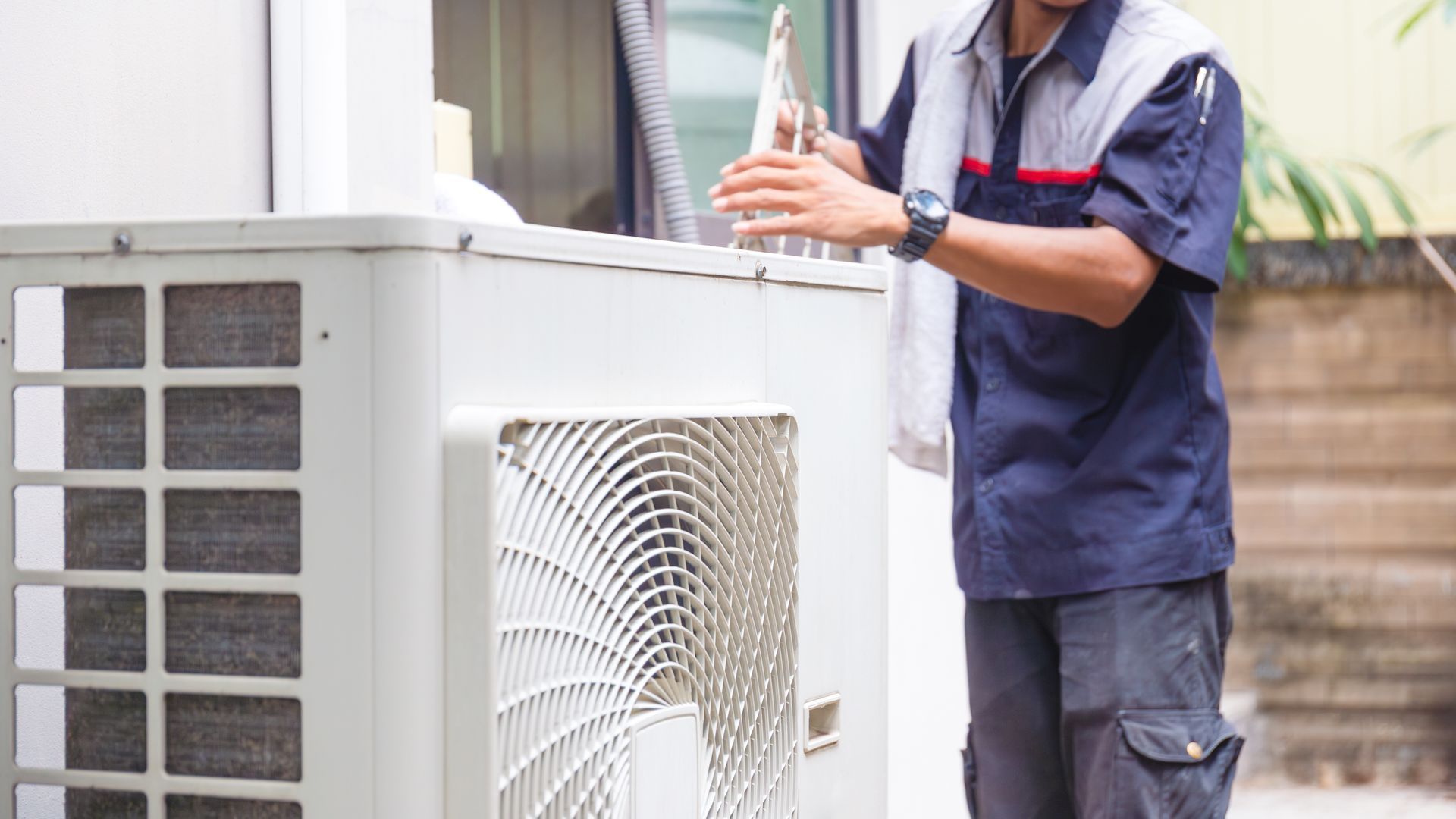 Air conditioner compressor with technician cleaning air conditioner