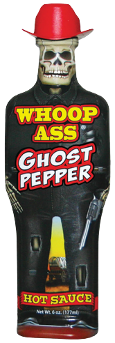 A bottle of Whoop Ass Ghost Pepper hot sauce shaped like a skeleton cowboy wearing a red hat and holding a pistol.