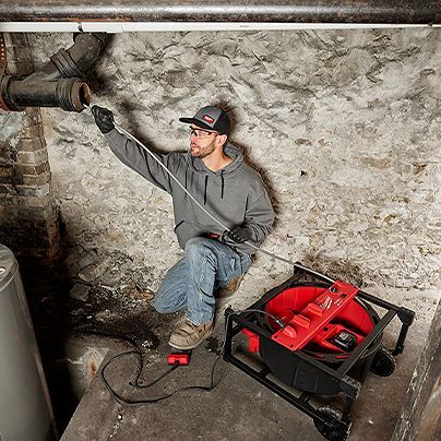 man working to unclog drain
