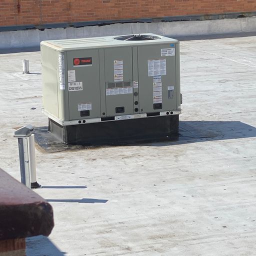 An air conditioner on the roof of a building