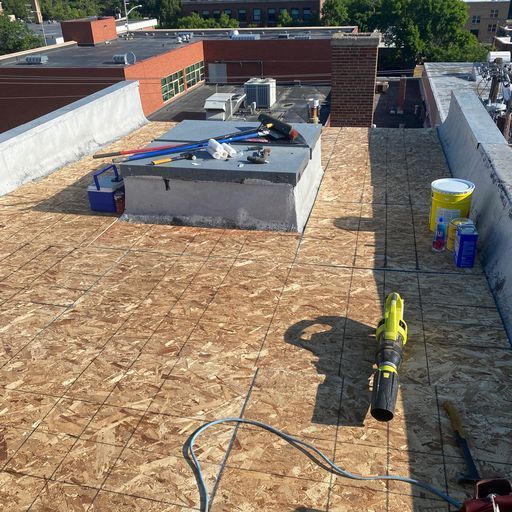 A blower is sitting on the roof of a building