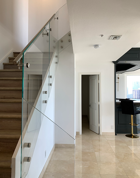 A staircase with a glass railing in a house
