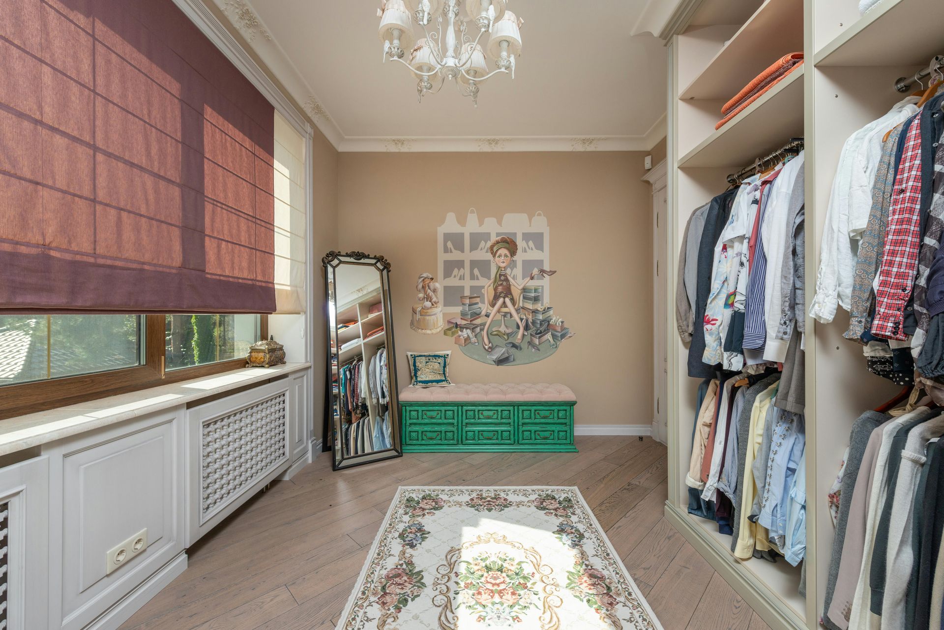 Walk-in closet with clothes racks, a large mirror, green storage, and a rug. Sunlight streams through a window.