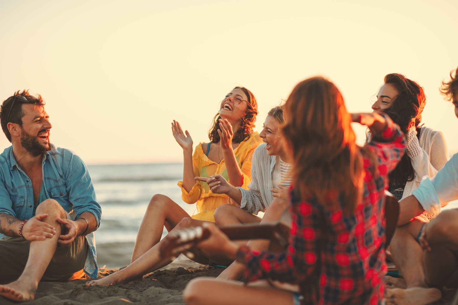friends smiling and laughing at the beach