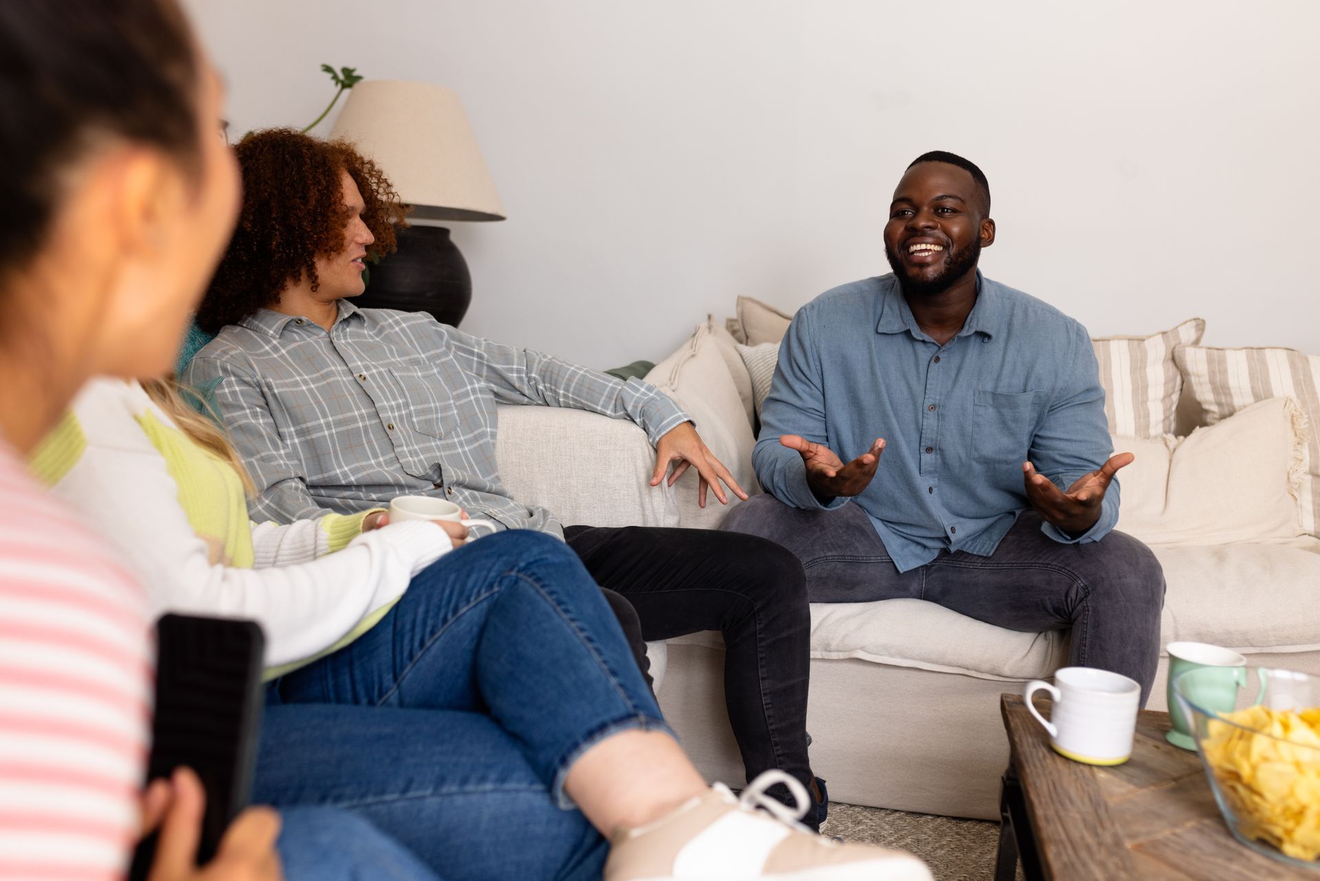 friends talking and eating snacks in a home
