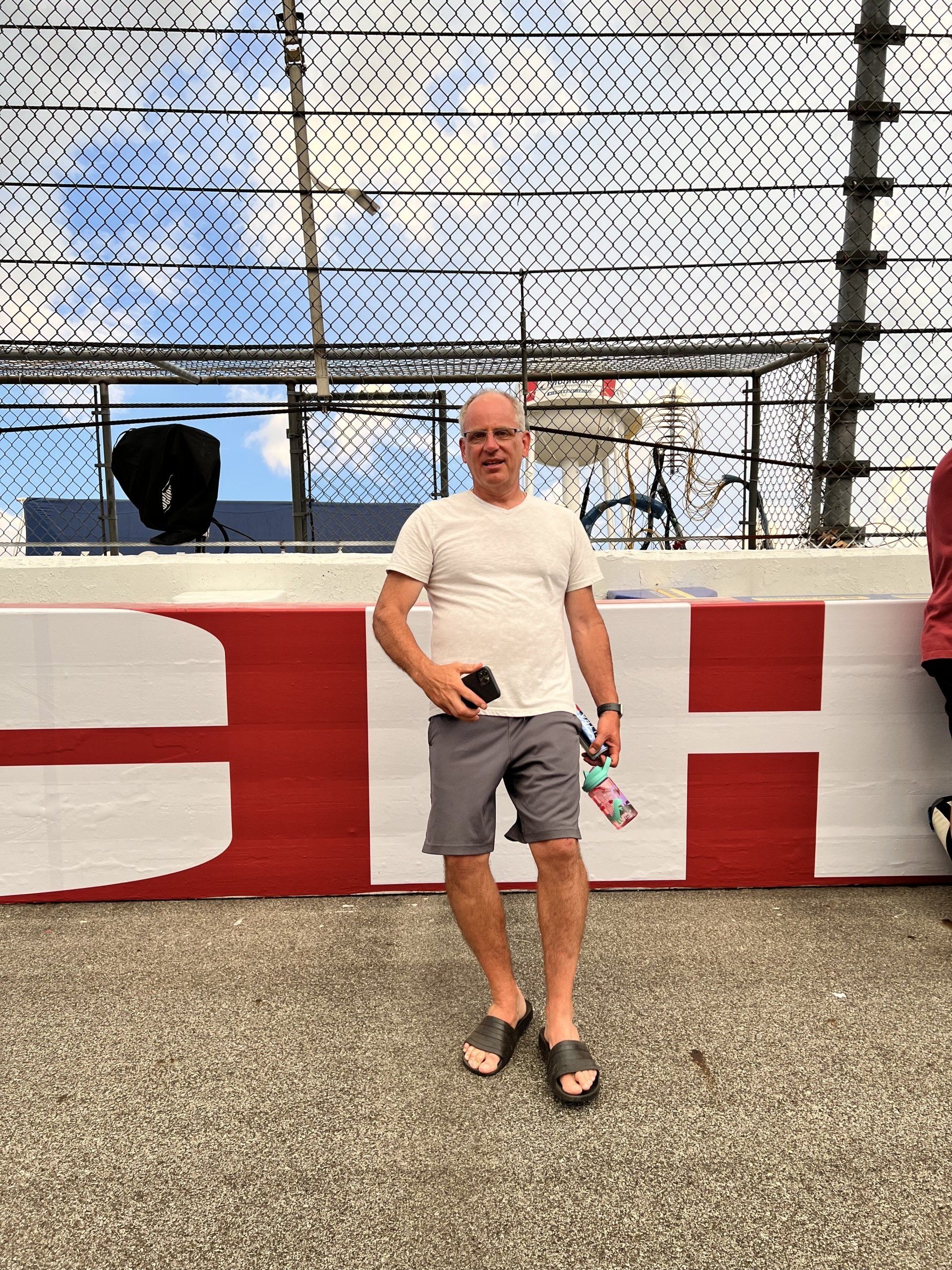 A man is standing in front of a sign that says h on it.