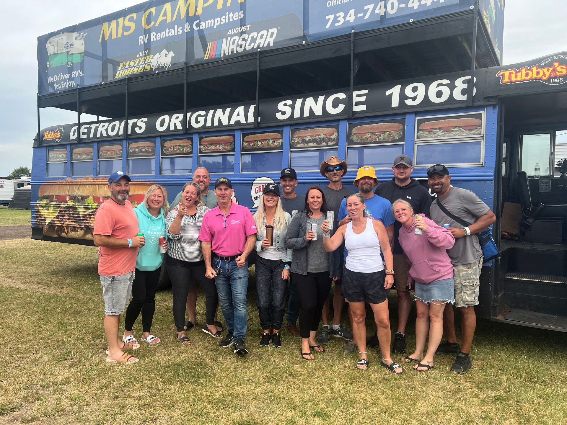 Group of people posing in front of a blue 