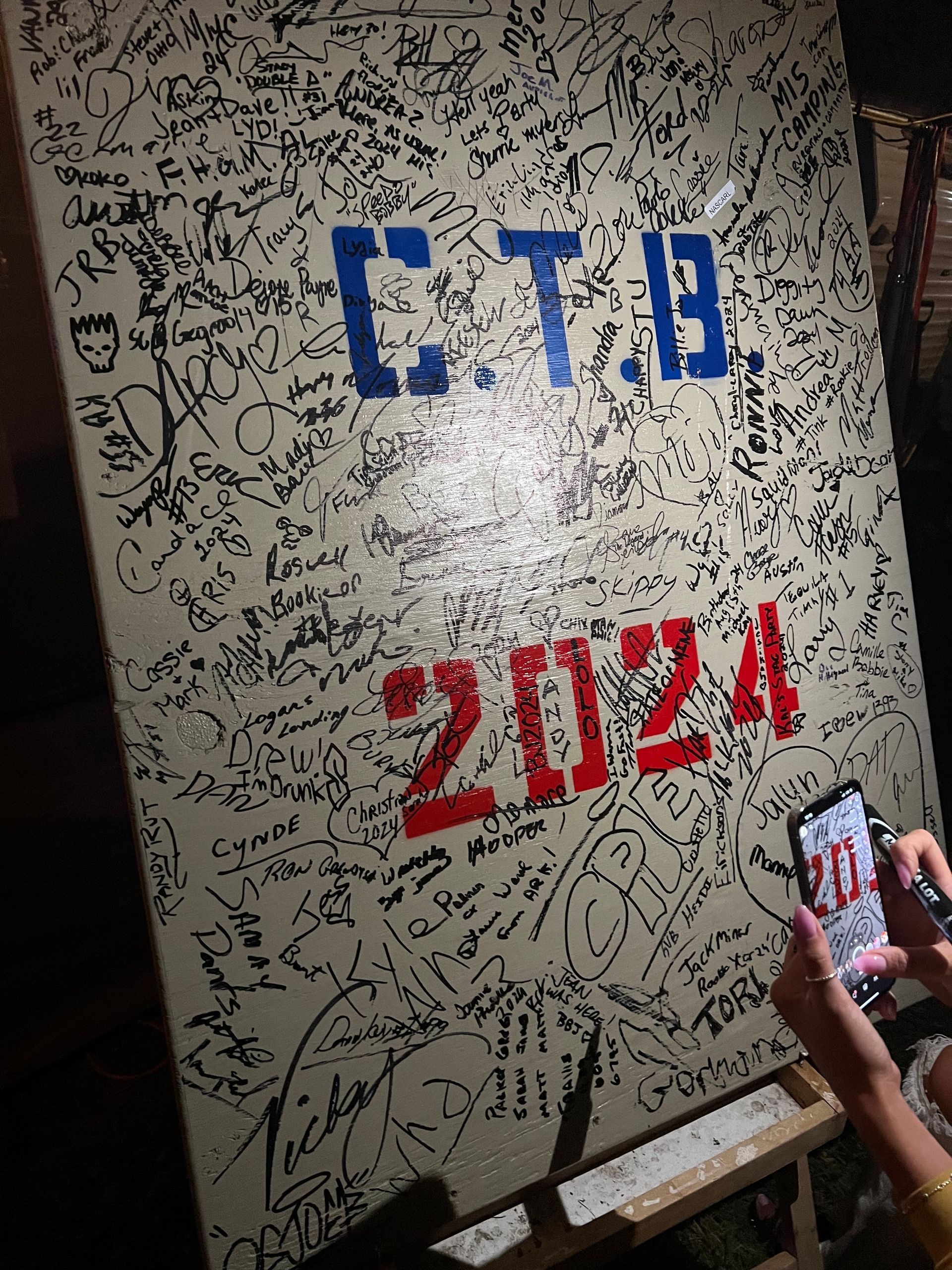 White board covered in signatures with 
