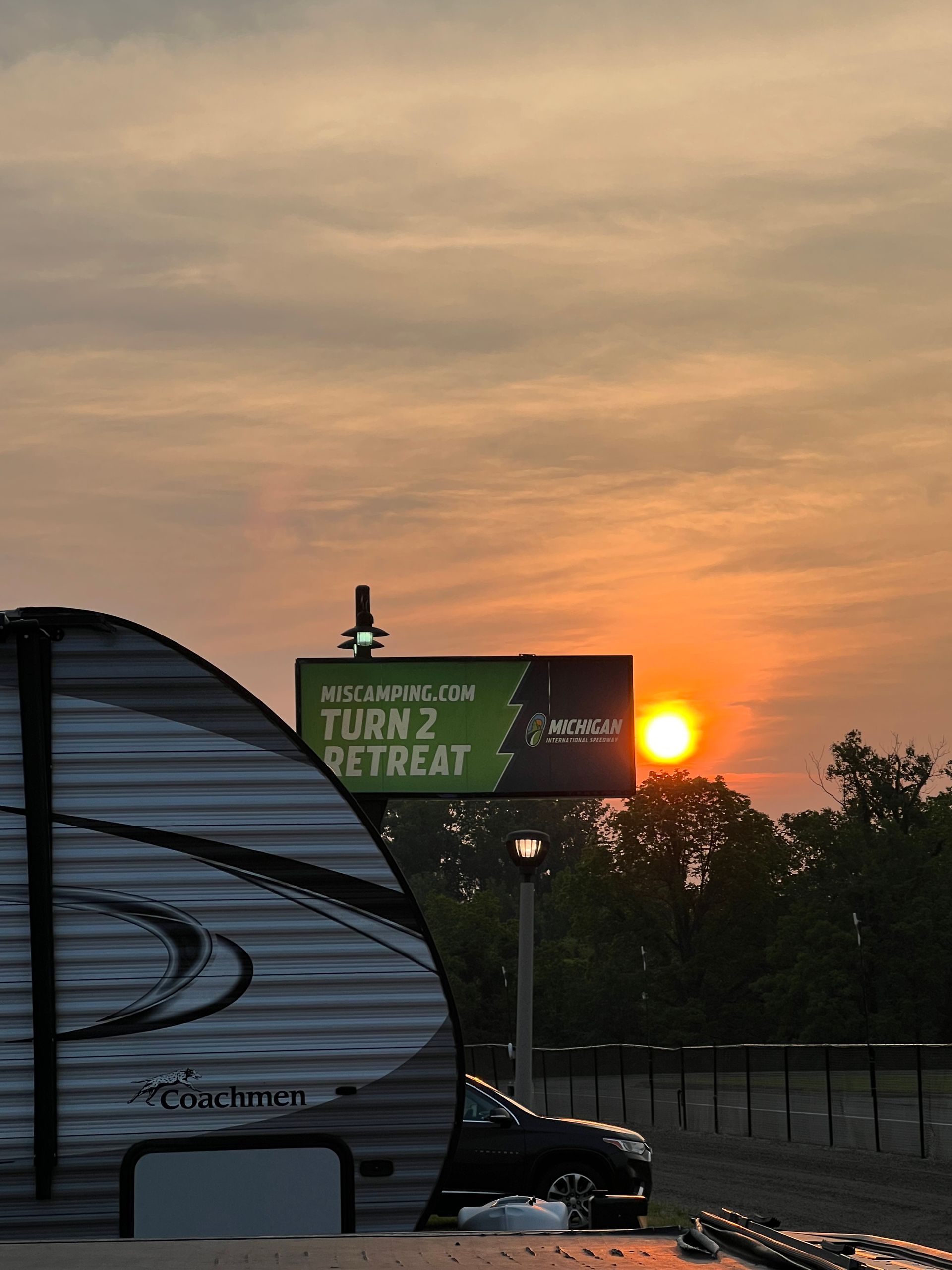 Sunset over a trailer, sign reading 