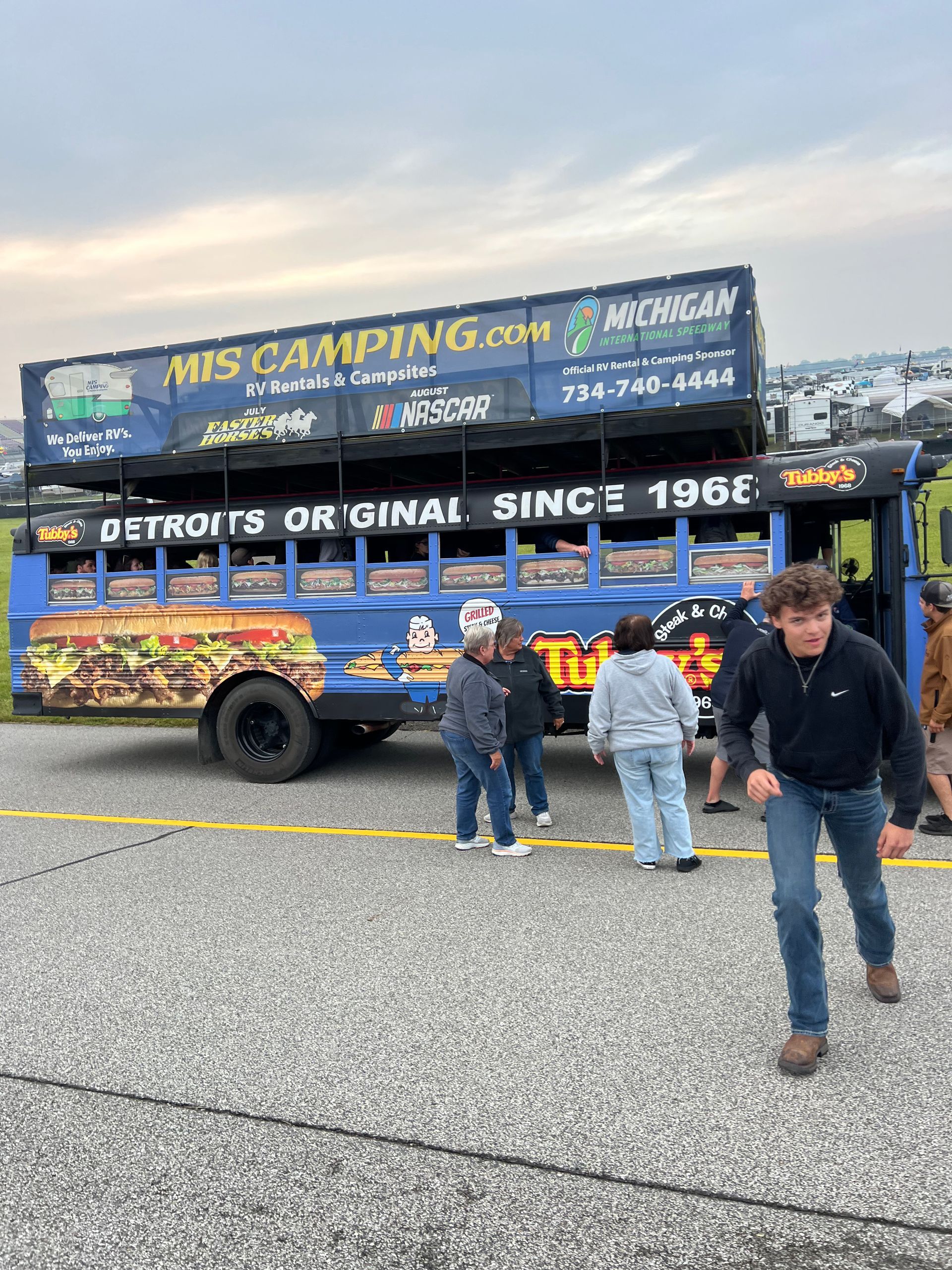 Blue bus modified for camping, labeled 