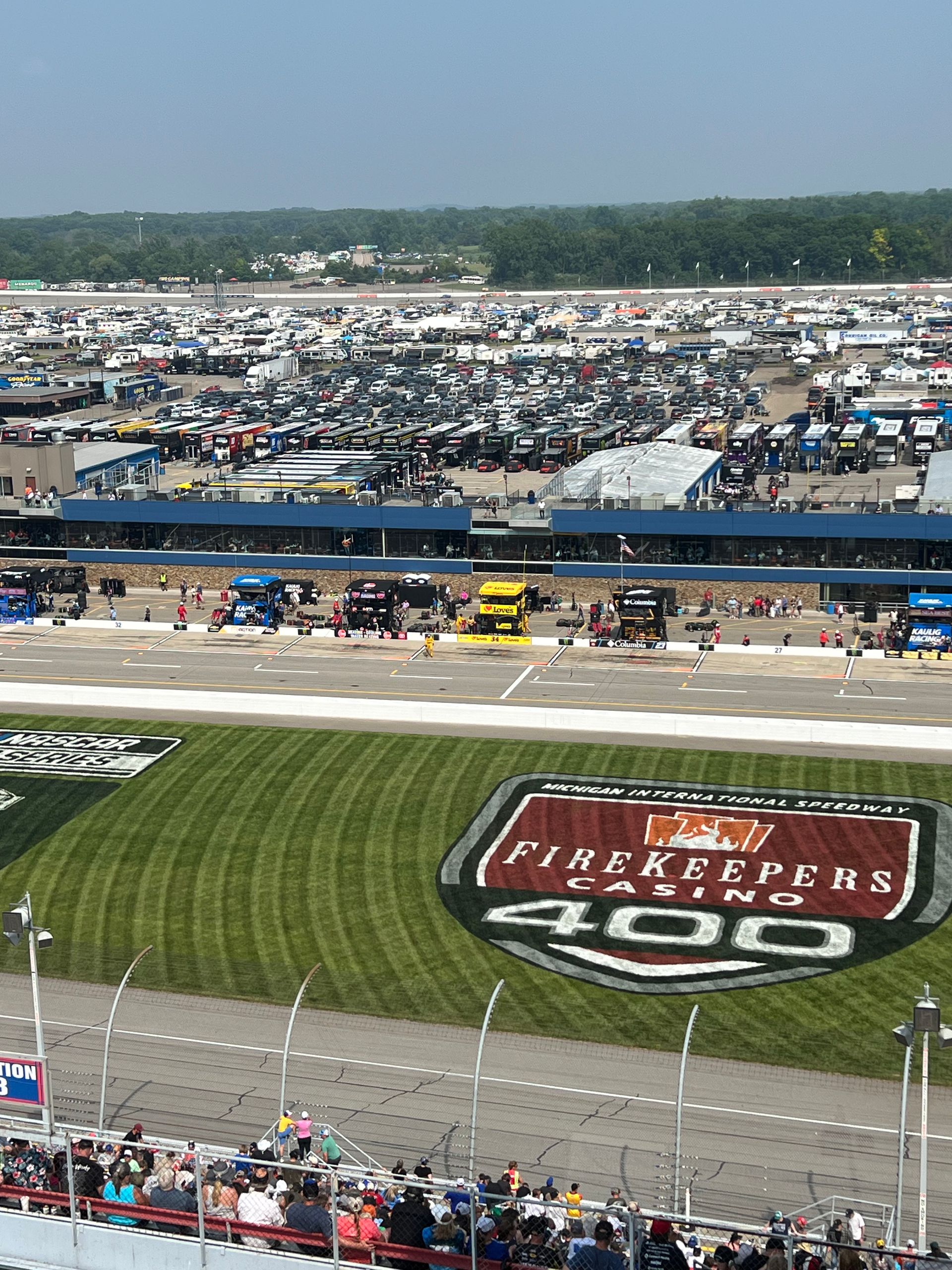 FireKeepers Casino 400 NASCAR race with cars, spectators, and logos on track and grassy infield.