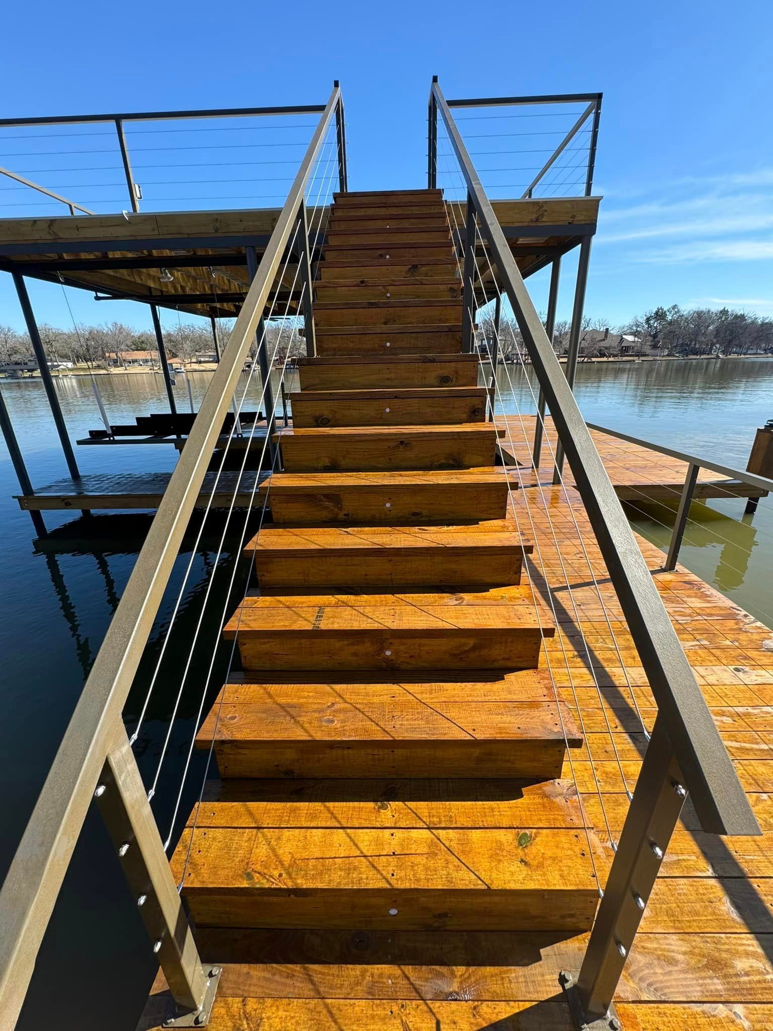 A set of wooden stairs leading up to a dock overlooking a body of water.