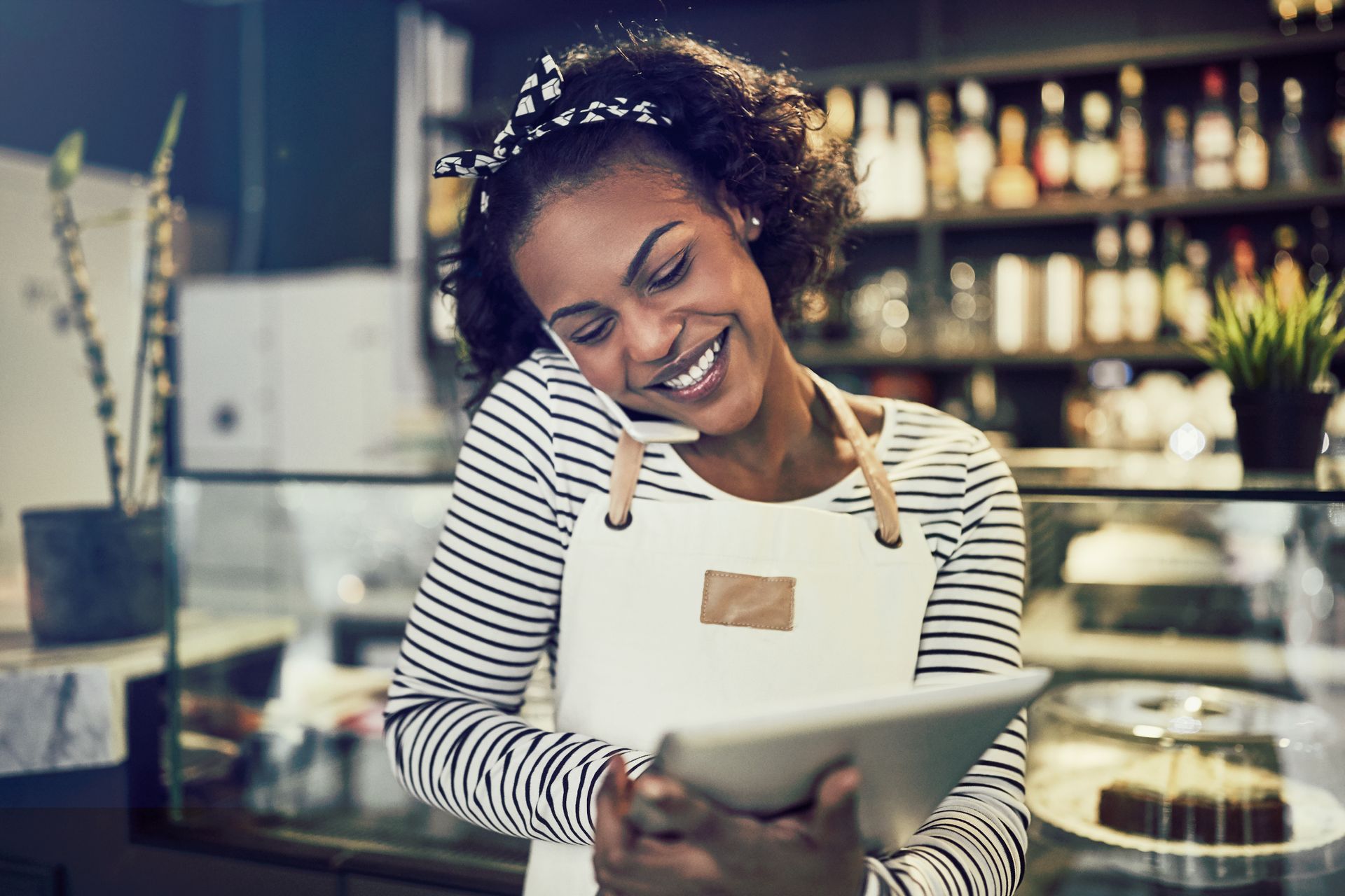Lady on a phone, working in a bar