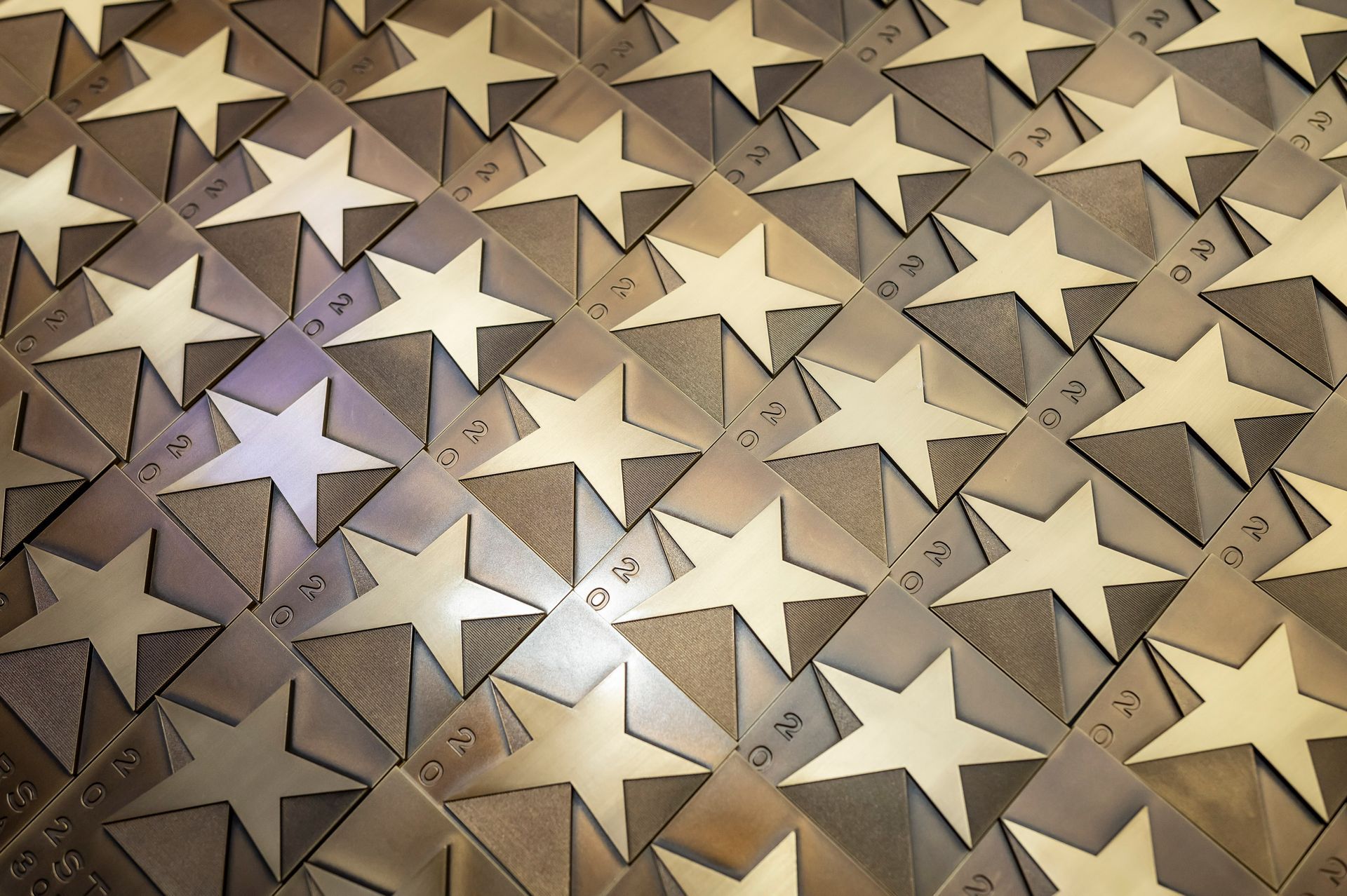Pattern of gold stars on a beige textured background