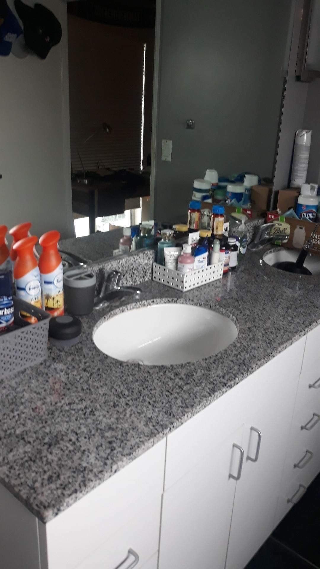 A bathroom counter with a sink and a mirror.