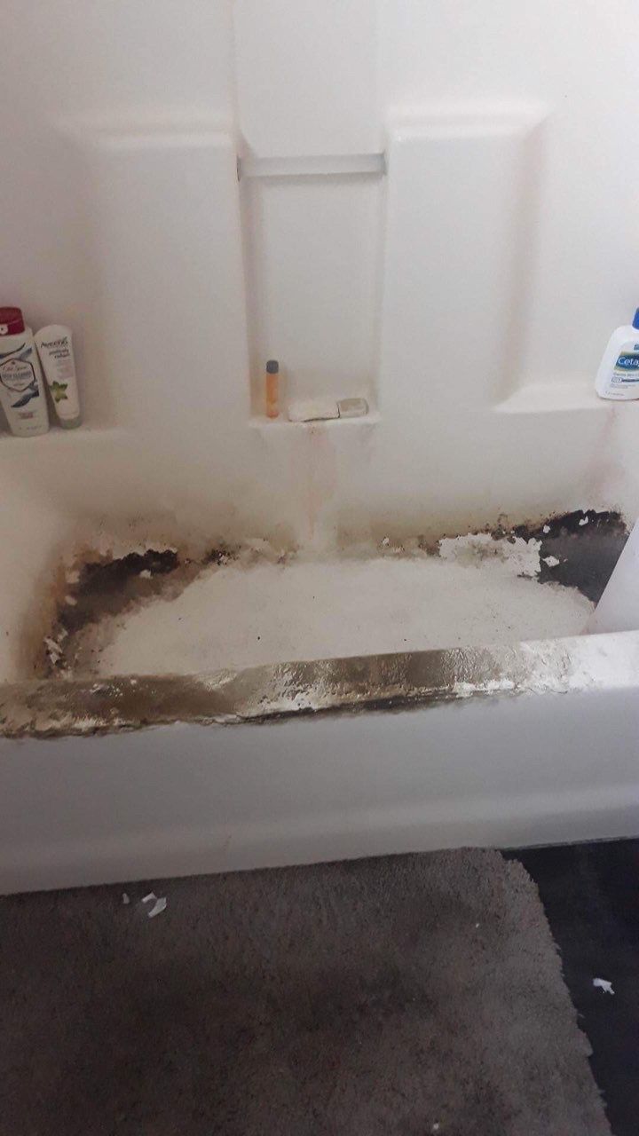 A bathtub is being remodeled in a bathroom.