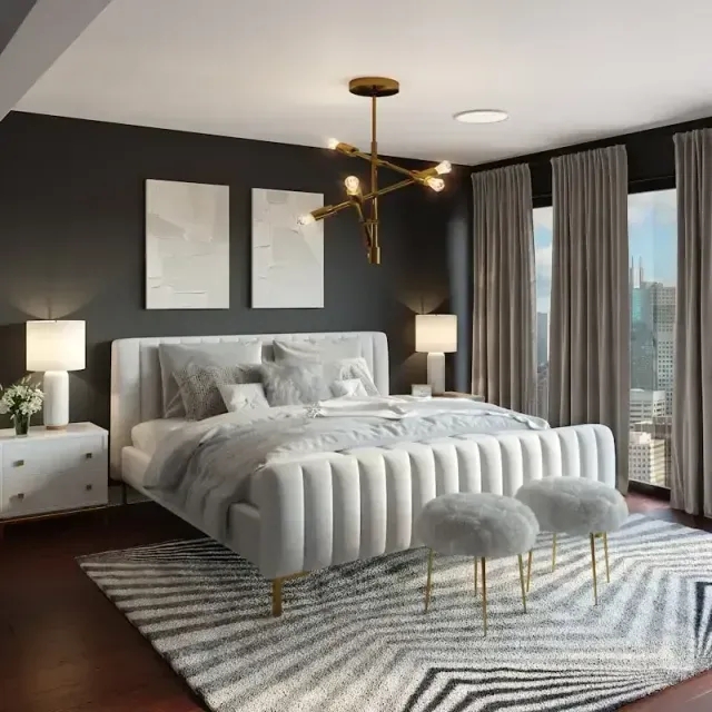 Modern bedroom with a tufted bed, dark walls, gold chandelier, and city-view windows