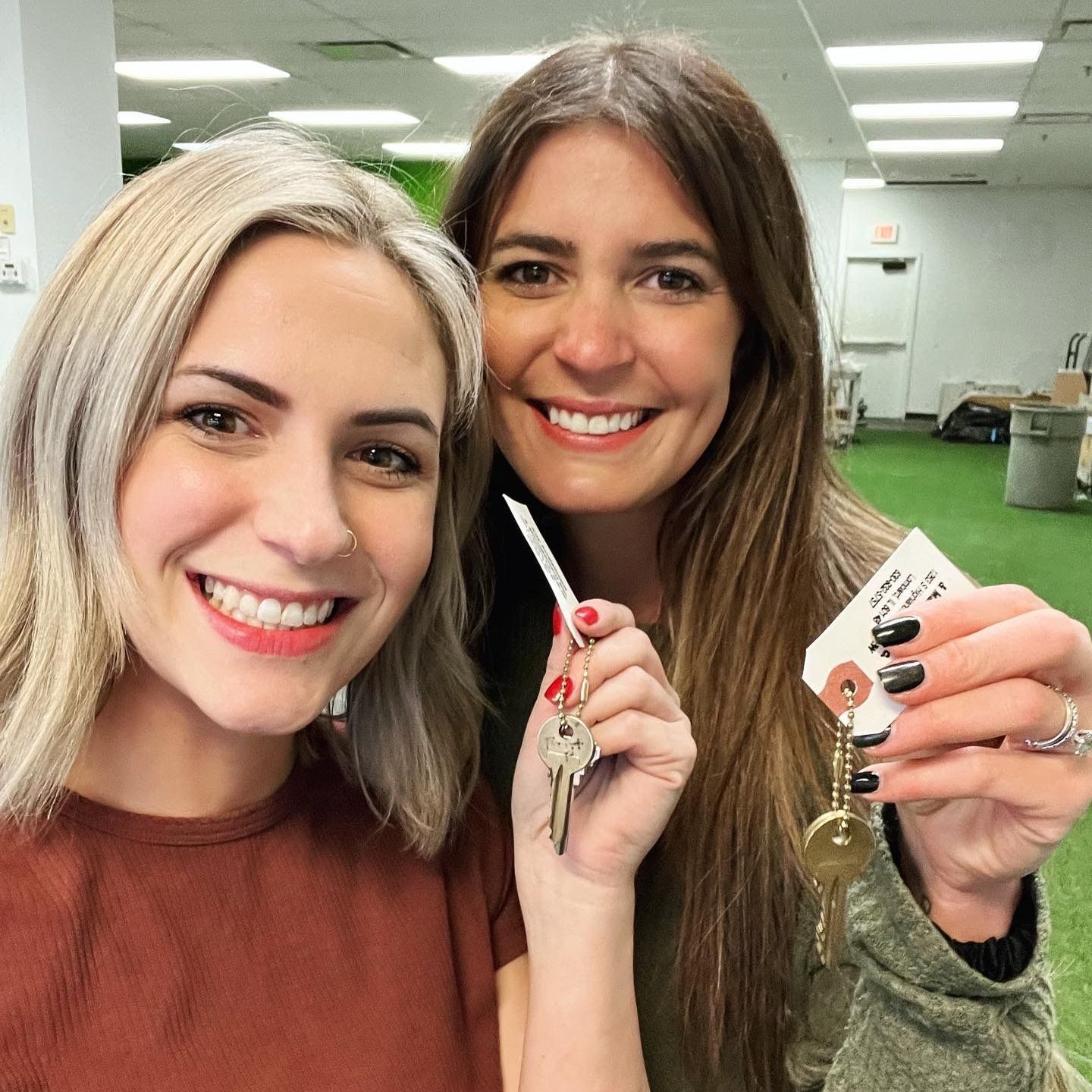 SISTER OWNED. LOMBARD GROWN Two women are smiling and holding keys in their hands