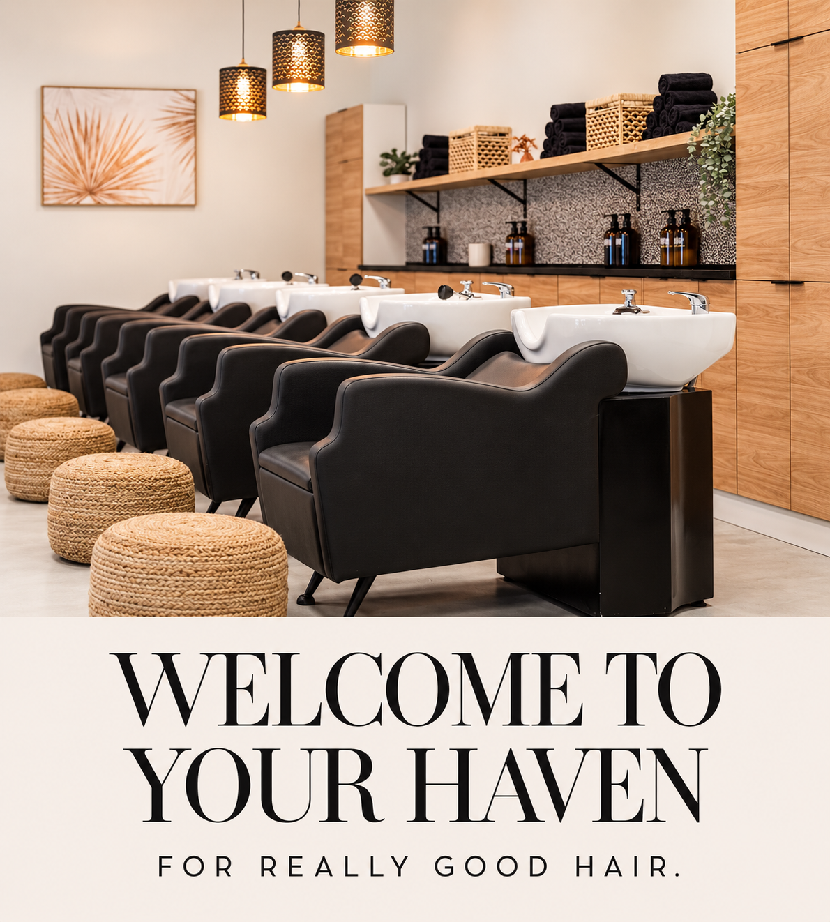 Modern salon interior with black styling chairs, pendant lights, and text reading “WELCOME TO YOUR HAVEN”
