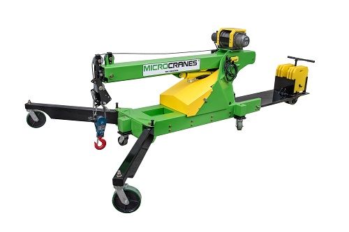 Stablizing Outrigger Legts Green and yellow mobile machine tool with black wheels and a hook attachment on a white background