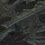 Dark wet surface with reflective water droplets and a diagonal cable or line across it