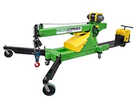 Green and yellow mobile boom lift with black wheels and red hook